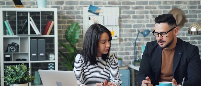 Two founders talking through a plan at a desk