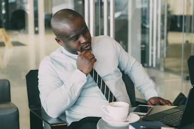 Someone pausing to think at their desk